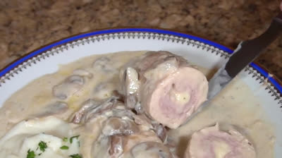 Chicken with ham and cheese and mushroom sauce