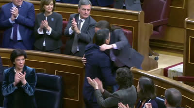 Pedro Sánchez and Pablo Iglesias embraced